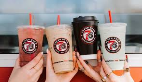 Friendly group of 7 Brew fans sharing drinks and recipe ideas at community meetup
